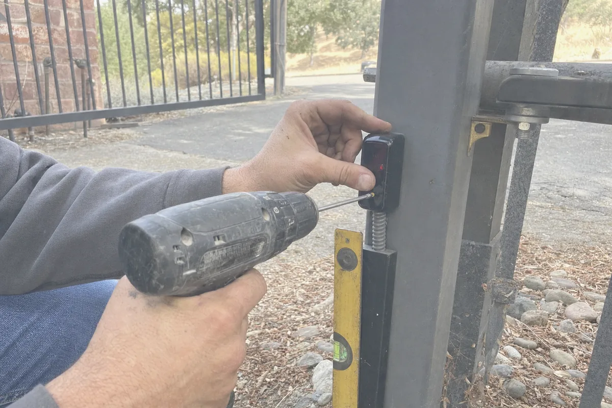 Close-up of automatic electric gate installation work in progress