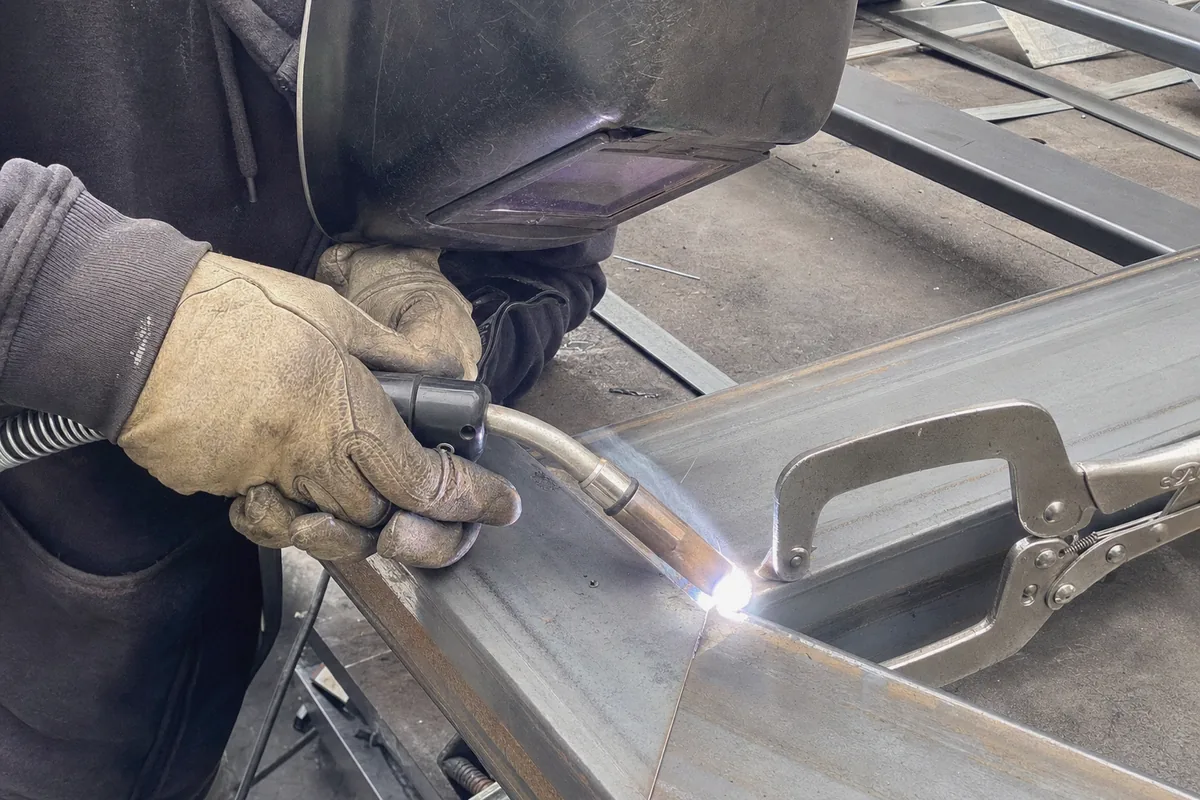 Close-up of custom metal gate fabrication work in progress